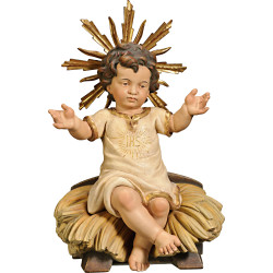 Niño Jesús vestido IHS sentado en cuna
